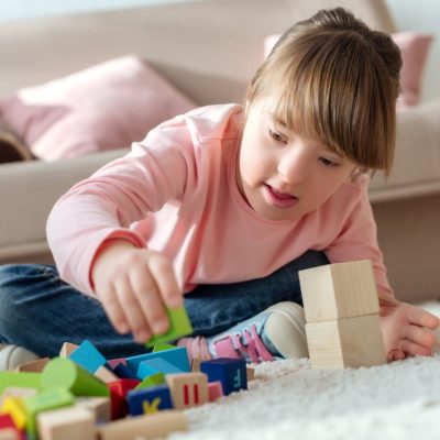 kid-with-down-syndrome-playing-with-toy-cubes.jpg